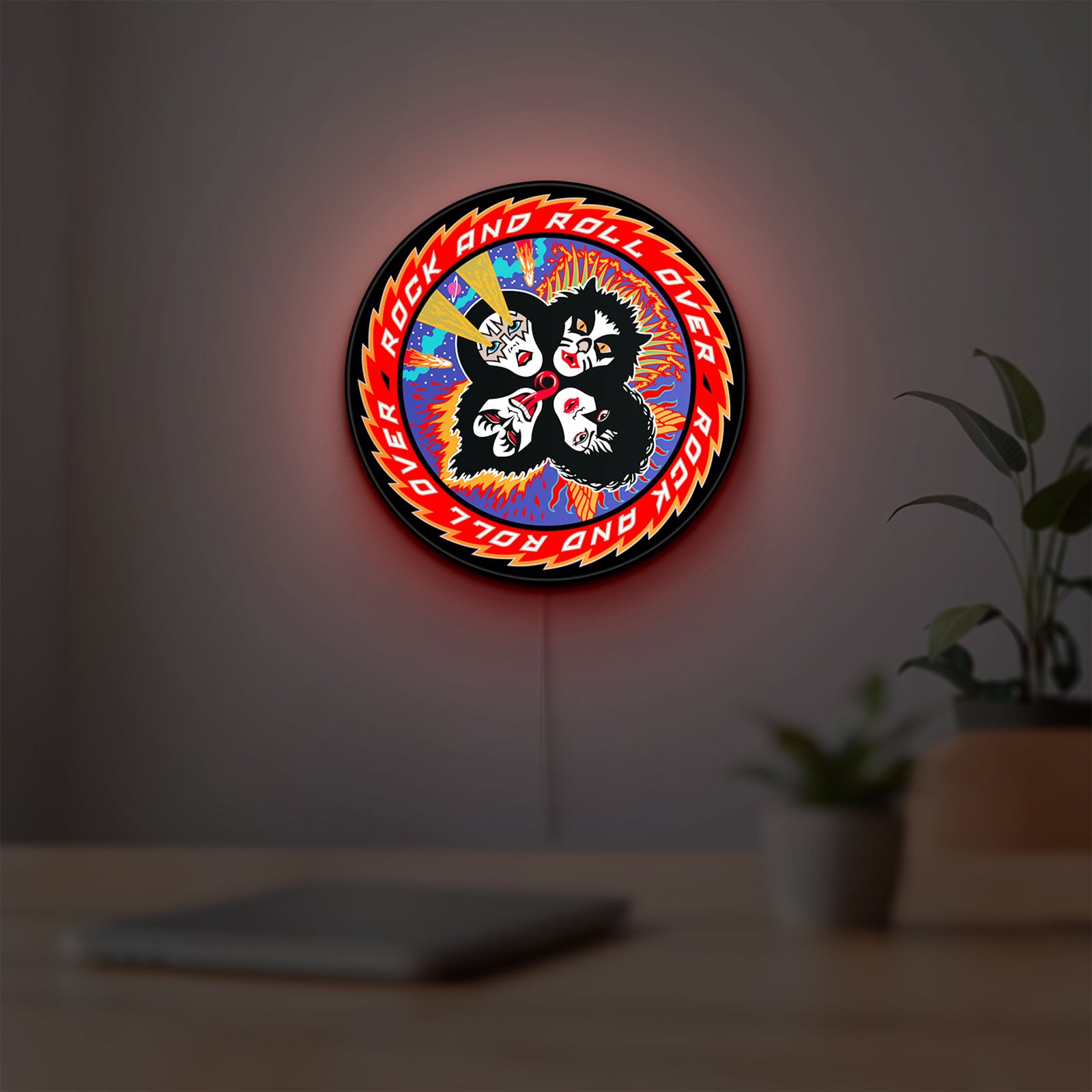 Kiss Rock And Roll Over LED lightbox hanging on a room wall with soft red light