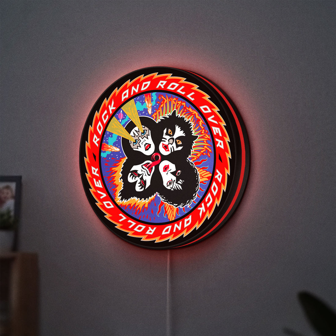 Kiss Rock And Roll Over LED lightbox hanging on a wall with red glow