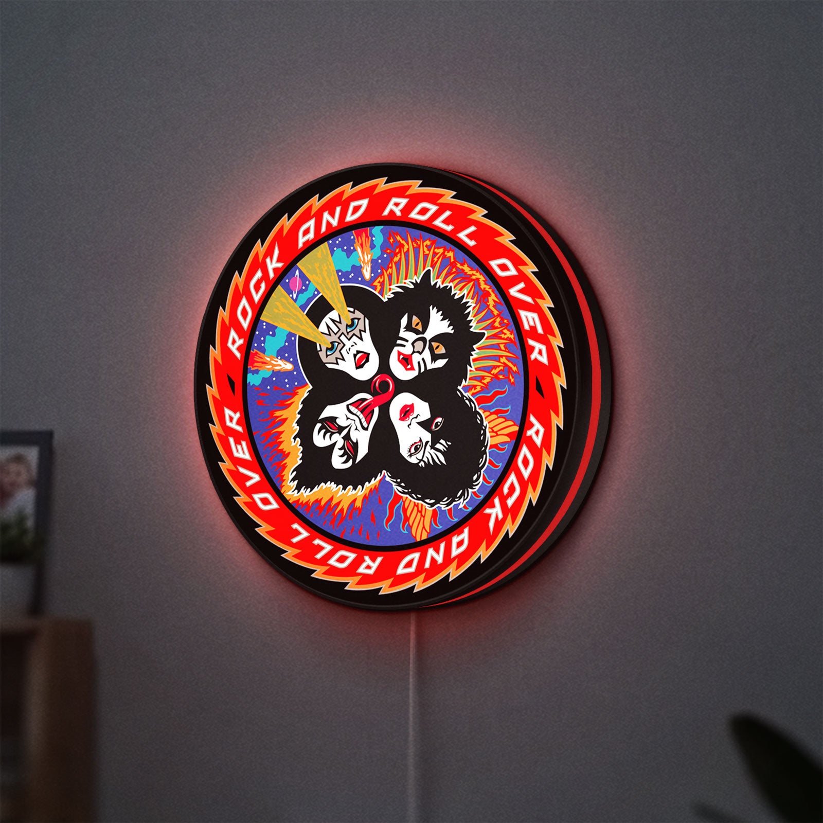 Kiss Rock And Roll Over LED lightbox hanging on a wall with red glow