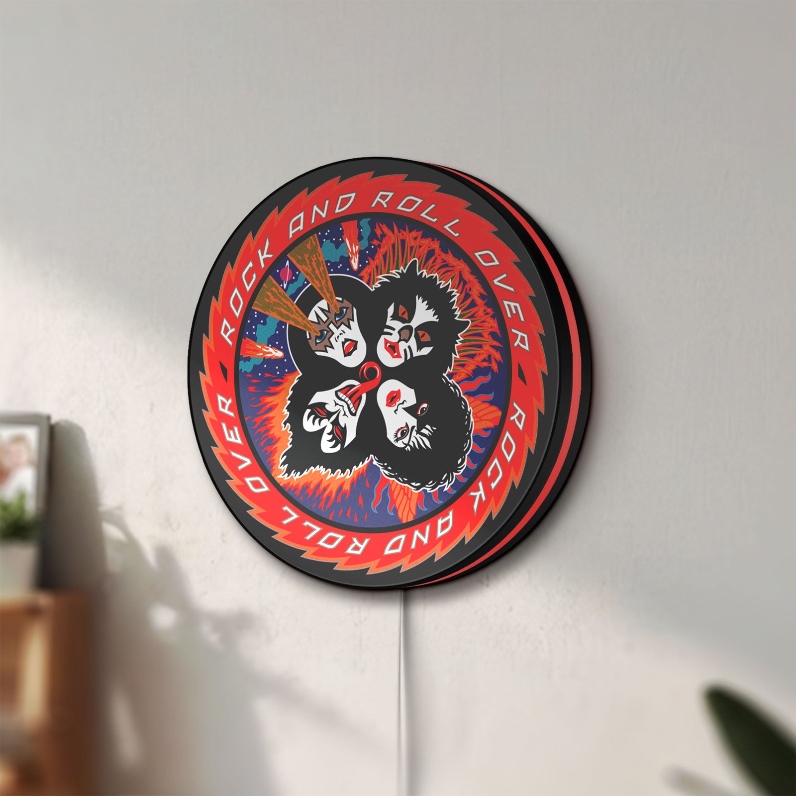 Unlit Kiss Rock And Roll Over LED lightbox mounted on a wall in daylight