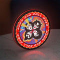 Kiss Rock And Roll Over LED lightbox standing on a desk from an angled side view with red glow