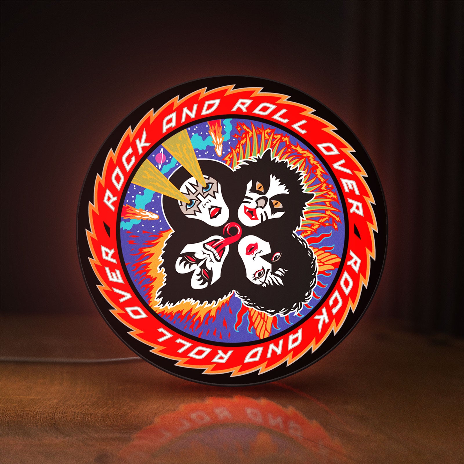Front view of Kiss Rock And Roll Over LED lightbox sign glowing on a wooden desk