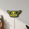 Unlit Aerosmith LED lightbox mounted on a wall in daylight