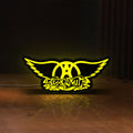 Front view of Aerosmith LED lightbox sign glowing on a wooden desk