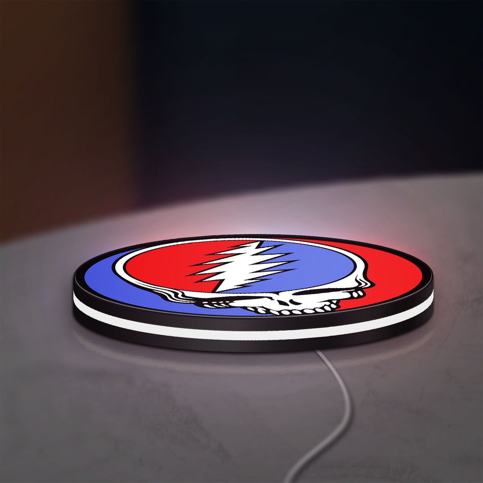 Grateful Dead LED lightbox lying flat on a desk with white glow