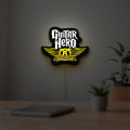 Aerosmith Guitar Hero LED lightbox hanging on a room wall with soft yellow light