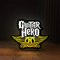 Front view of Aerosmith Guitar Hero LED lightbox sign glowing on a wooden desk