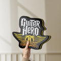 Unlit Aerosmith Guitar Hero LED lightbox held by hand to show size and details