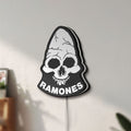 Unlit Ramones LED lightbox mounted on a wall in daylight