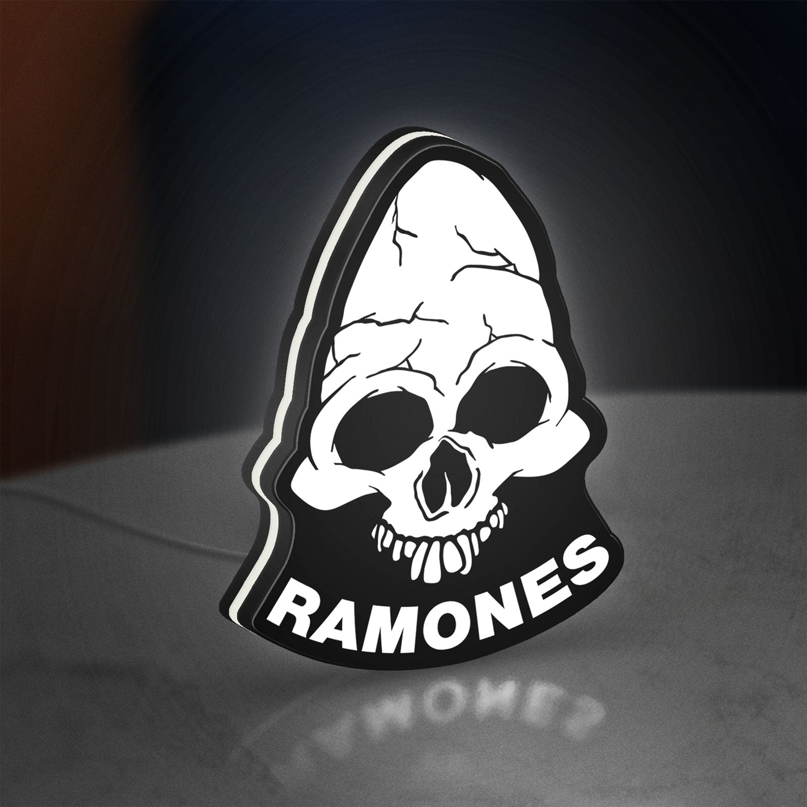 Ramones LED lightbox standing on a desk from an angled side view with white glow