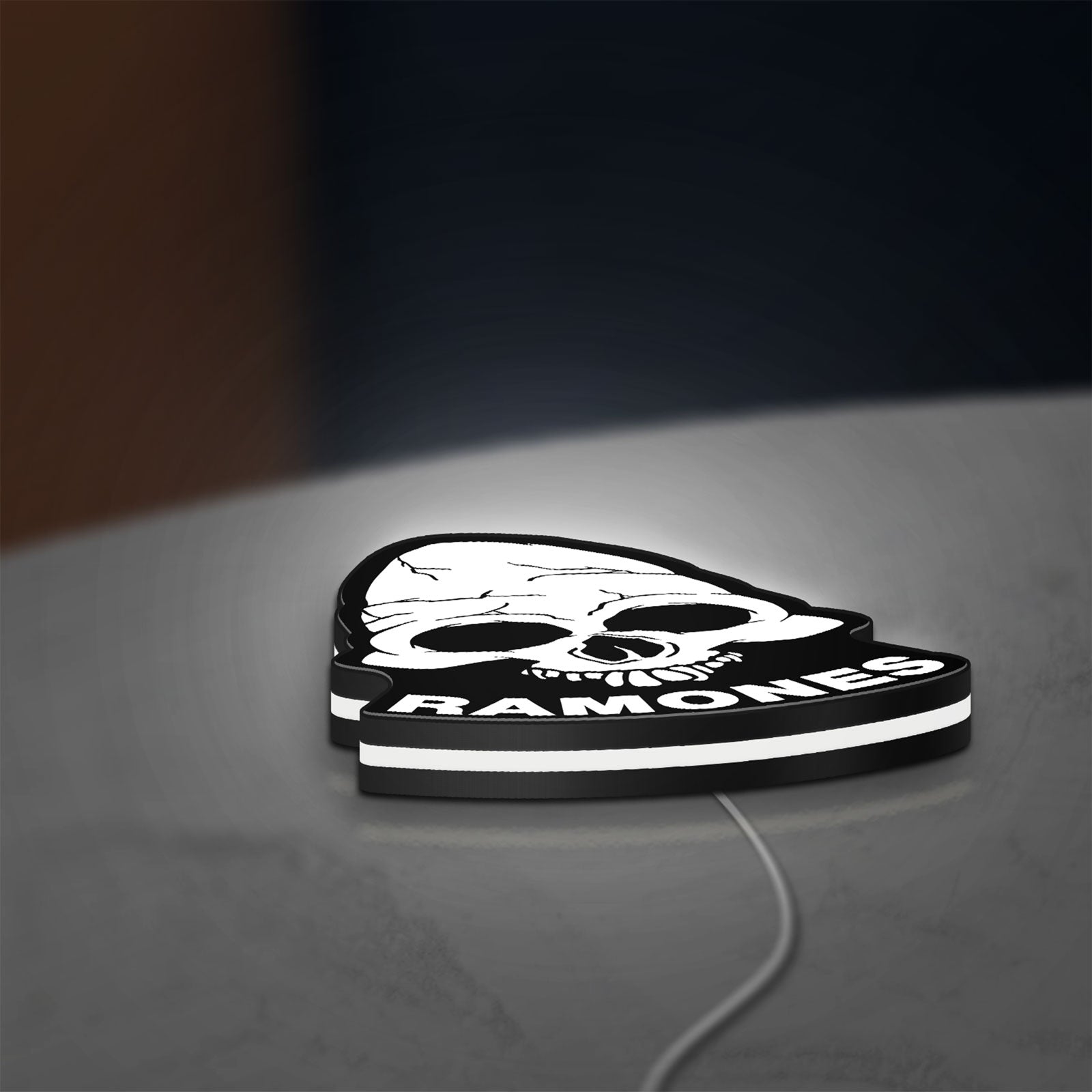 Ramones LED lightbox lying flat on a desk with white glow