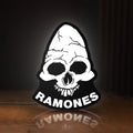 Front view of Ramones LED lightbox sign glowing on a wooden desk