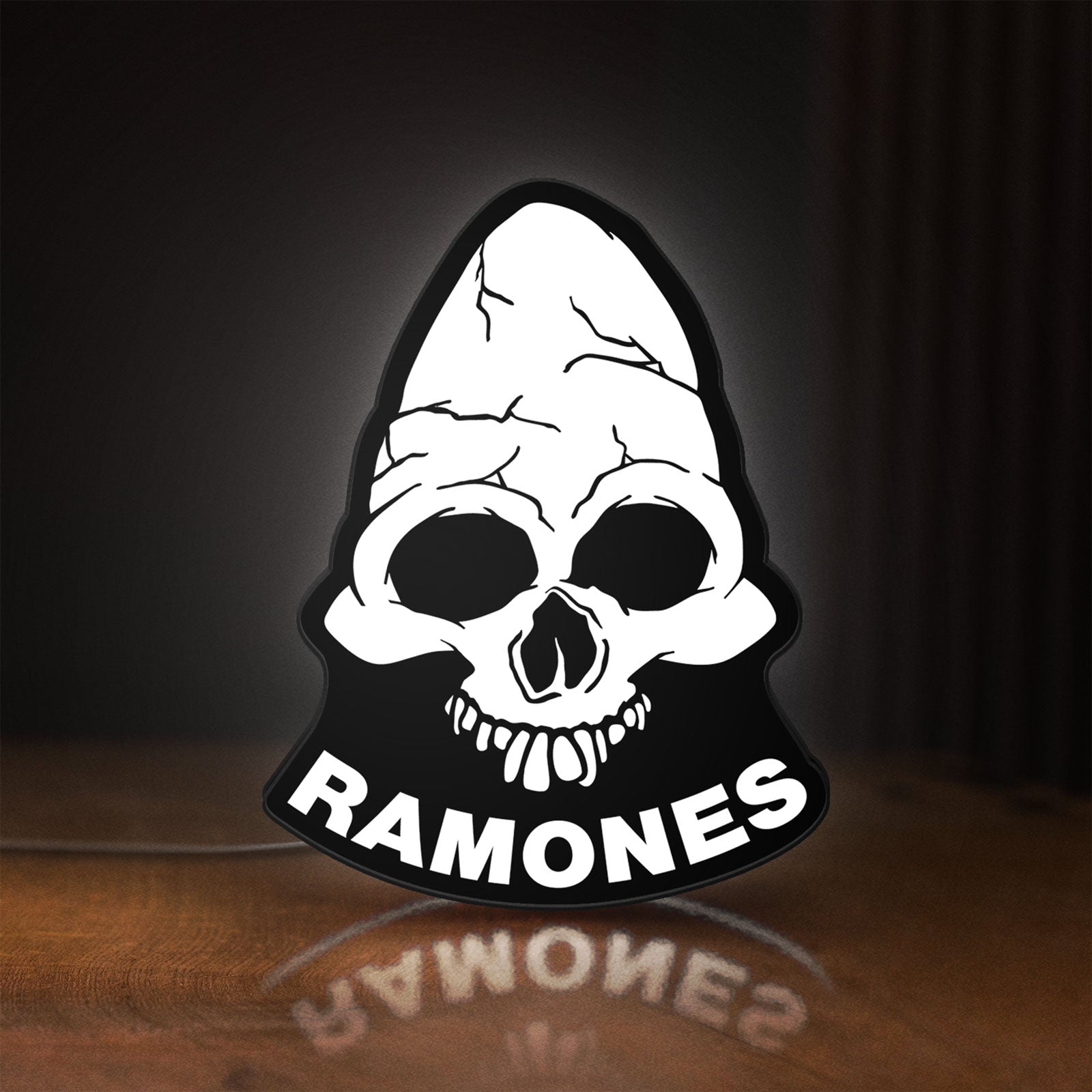 Front view of Ramones LED lightbox sign glowing on a wooden desk