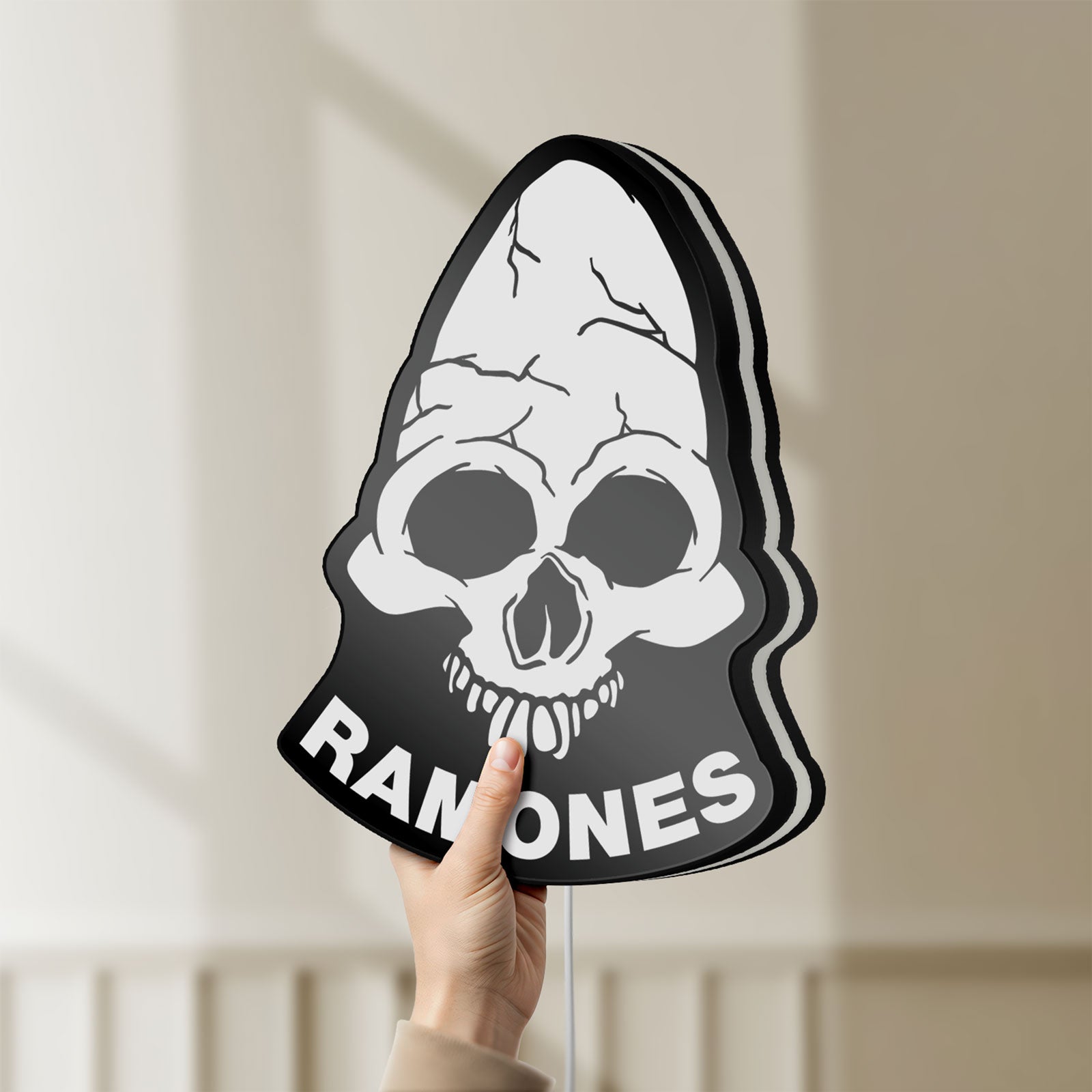 Unlit Ramones LED lightbox held by hand to show size and details