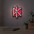 Dead Kennedys LED lightbox hanging on a room wall with soft white light