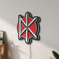 Unlit Dead Kennedys LED lightbox mounted on a wall in daylight