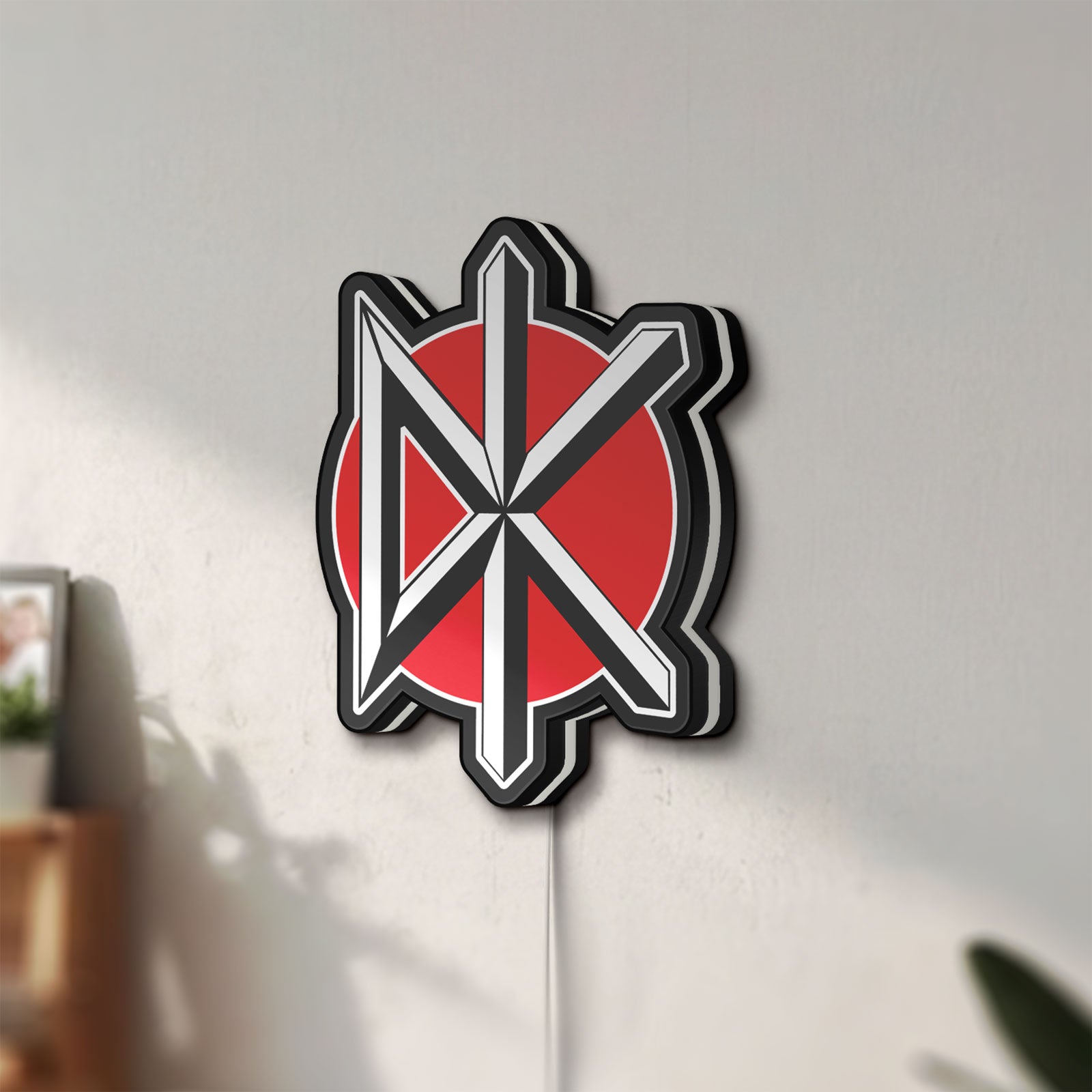 Unlit Dead Kennedys LED lightbox mounted on a wall in daylight