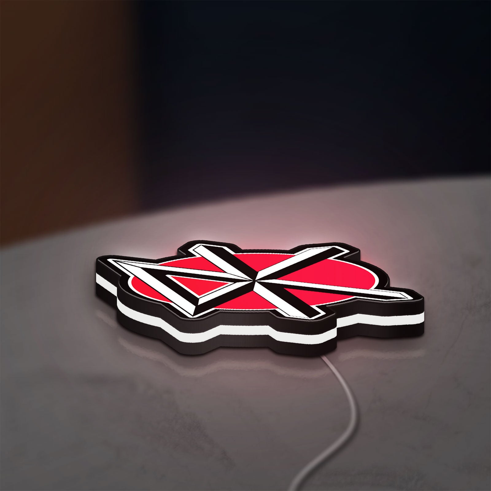 Dead Kennedys LED lightbox lying flat on a desk with white glow