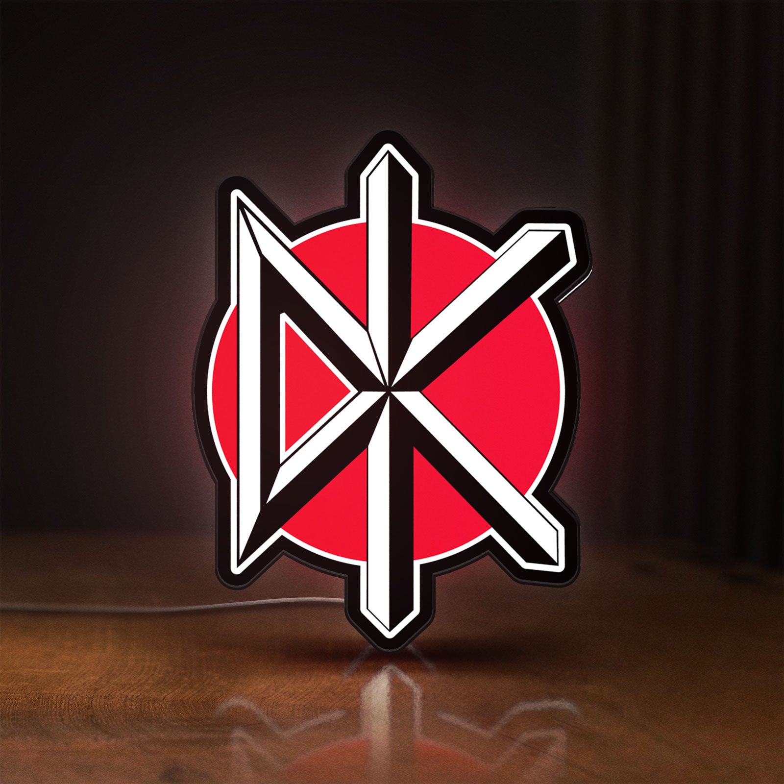 Front view of Dead Kennedys LED lightbox sign glowing on a wooden desk