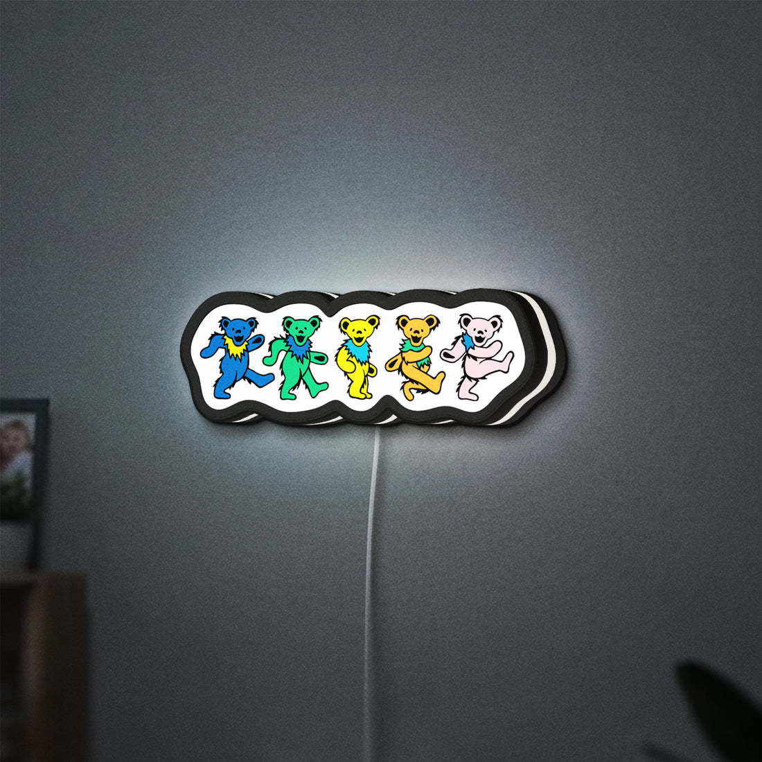 Grateful Dead Dancing Bears LED lightbox hanging on a wall with white glow