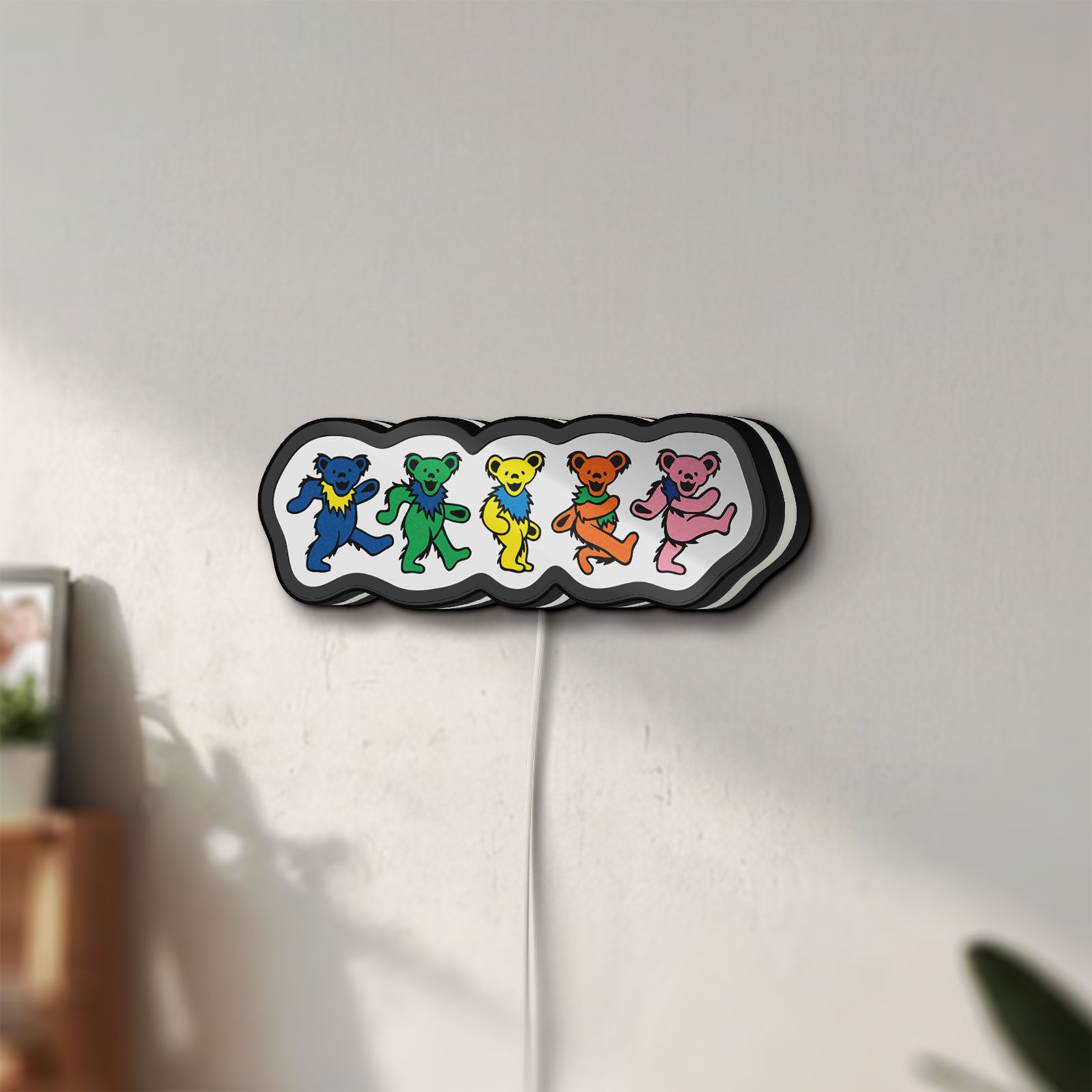 Unlit Grateful Dead Dancing Bears LED lightbox mounted on a wall in daylight