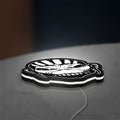 Iron Maiden The Book Of Souls LED lightbox lying flat on a desk with white glow