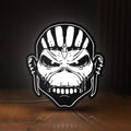 Front view of Iron Maiden The Book Of Souls LED lightbox sign glowing on a wooden desk