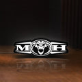 Front view of Masters Of Hardcore LED lightbox sign glowing on a wooden desk