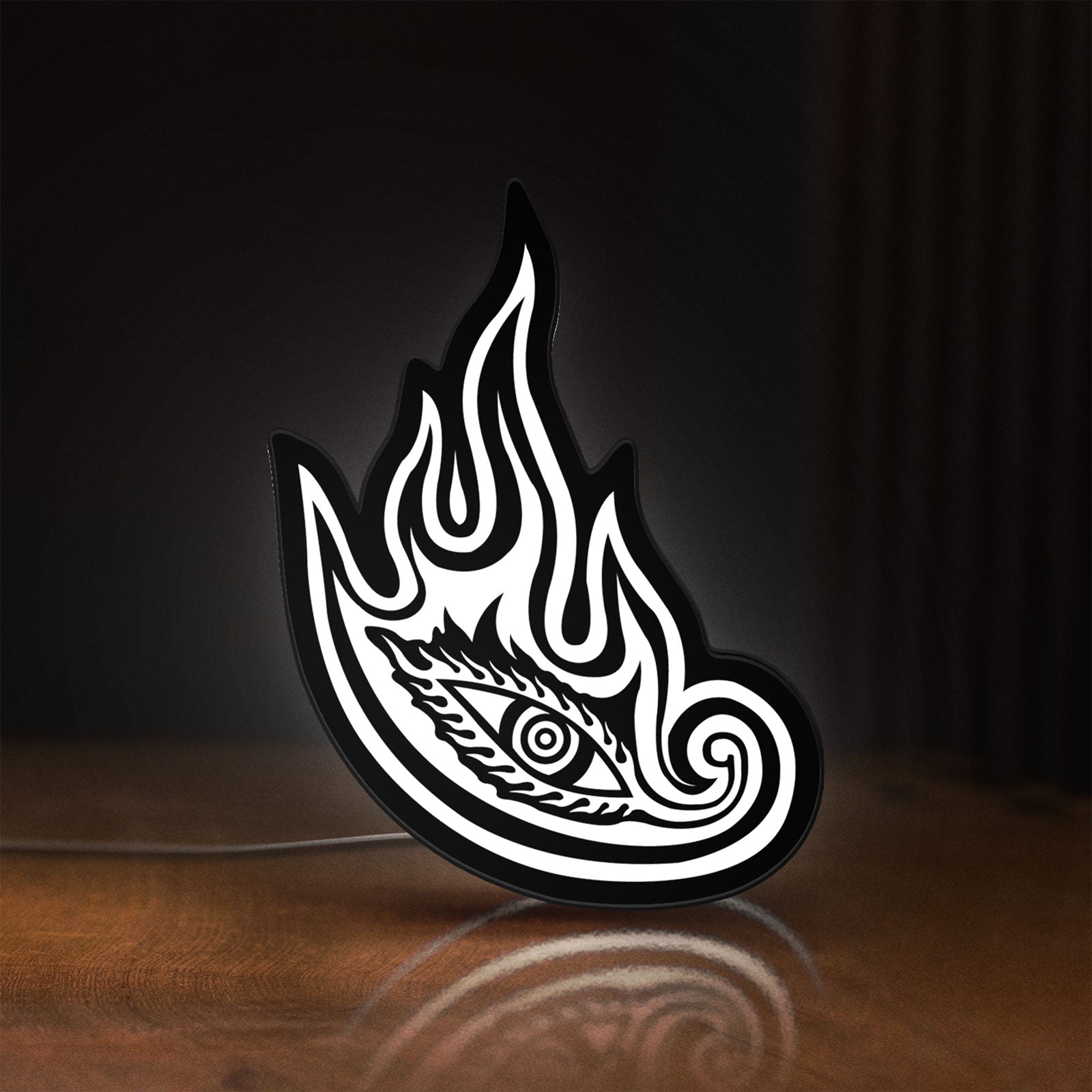 Front view of Tool Lateralus Eye LED lightbox sign glowing on a wooden desk