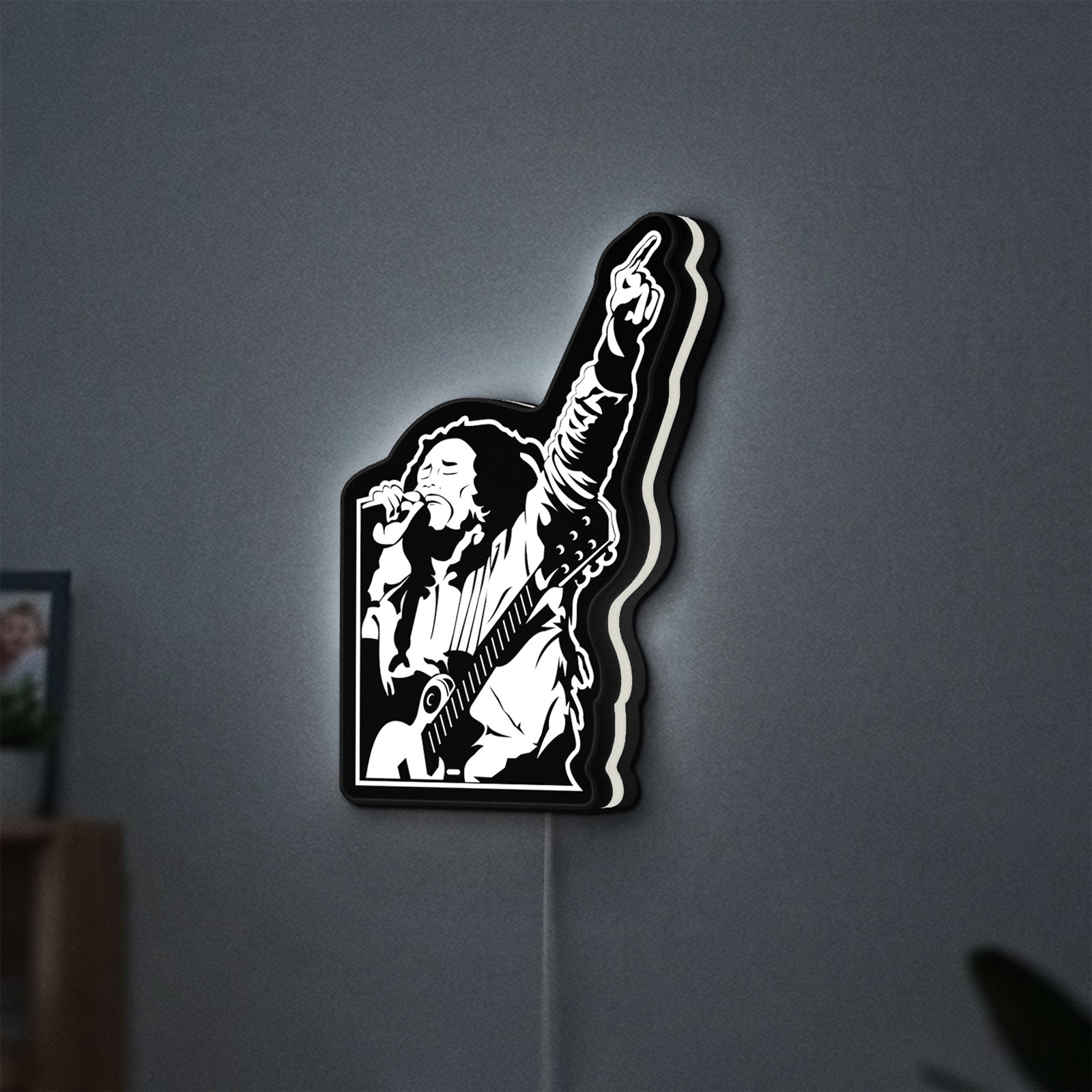 Bob Marley LED lightbox hanging on a wall with white glow