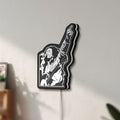 Unlit Bob Marley LED lightbox mounted on a wall in daylight