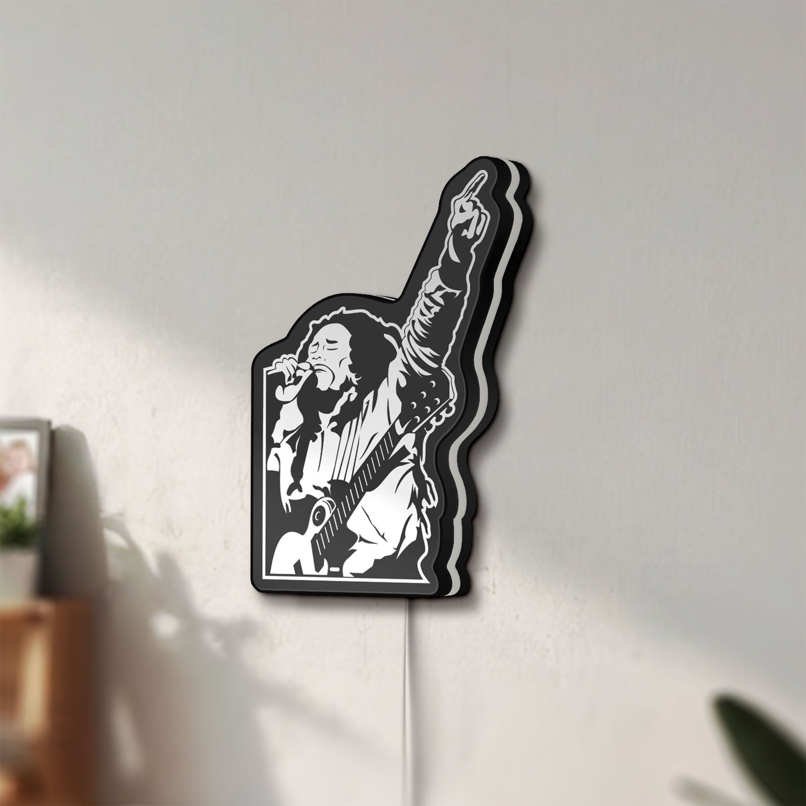 Unlit Bob Marley LED lightbox mounted on a wall in daylight
