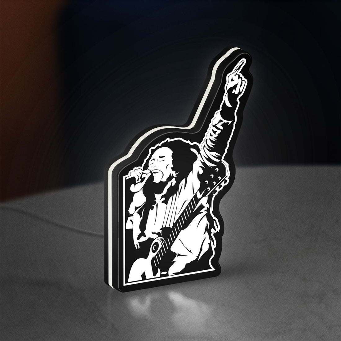 Bob Marley LED lightbox hanging on a wall with white glow