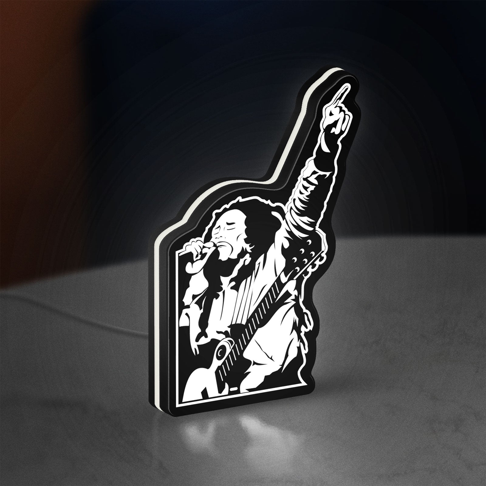 Bob Marley LED lightbox standing on a desk from an angled side view with white glow