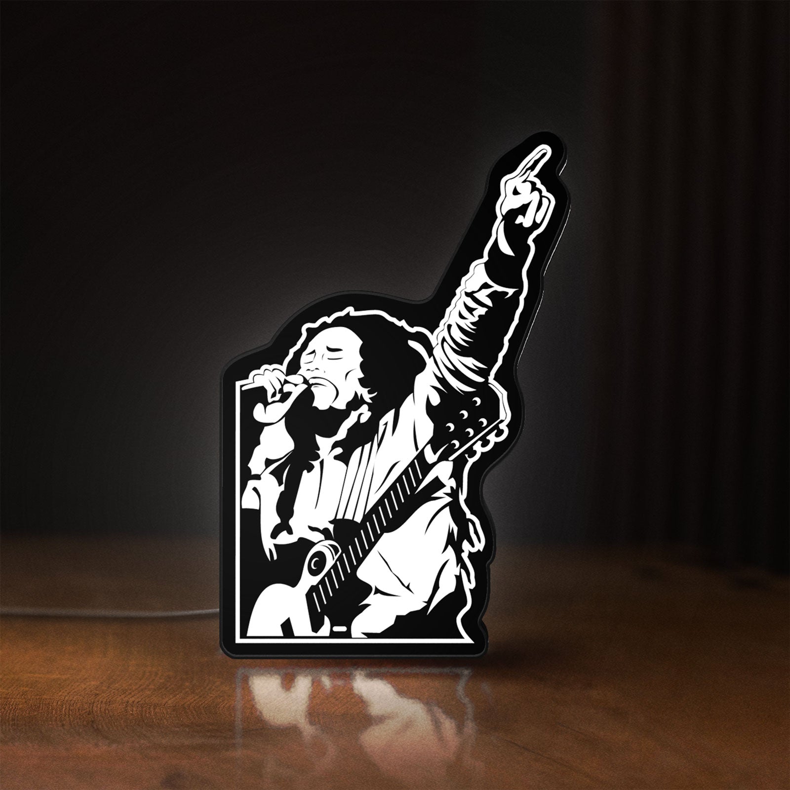 Front view of Bob Marley LED lightbox sign glowing on a wooden desk
