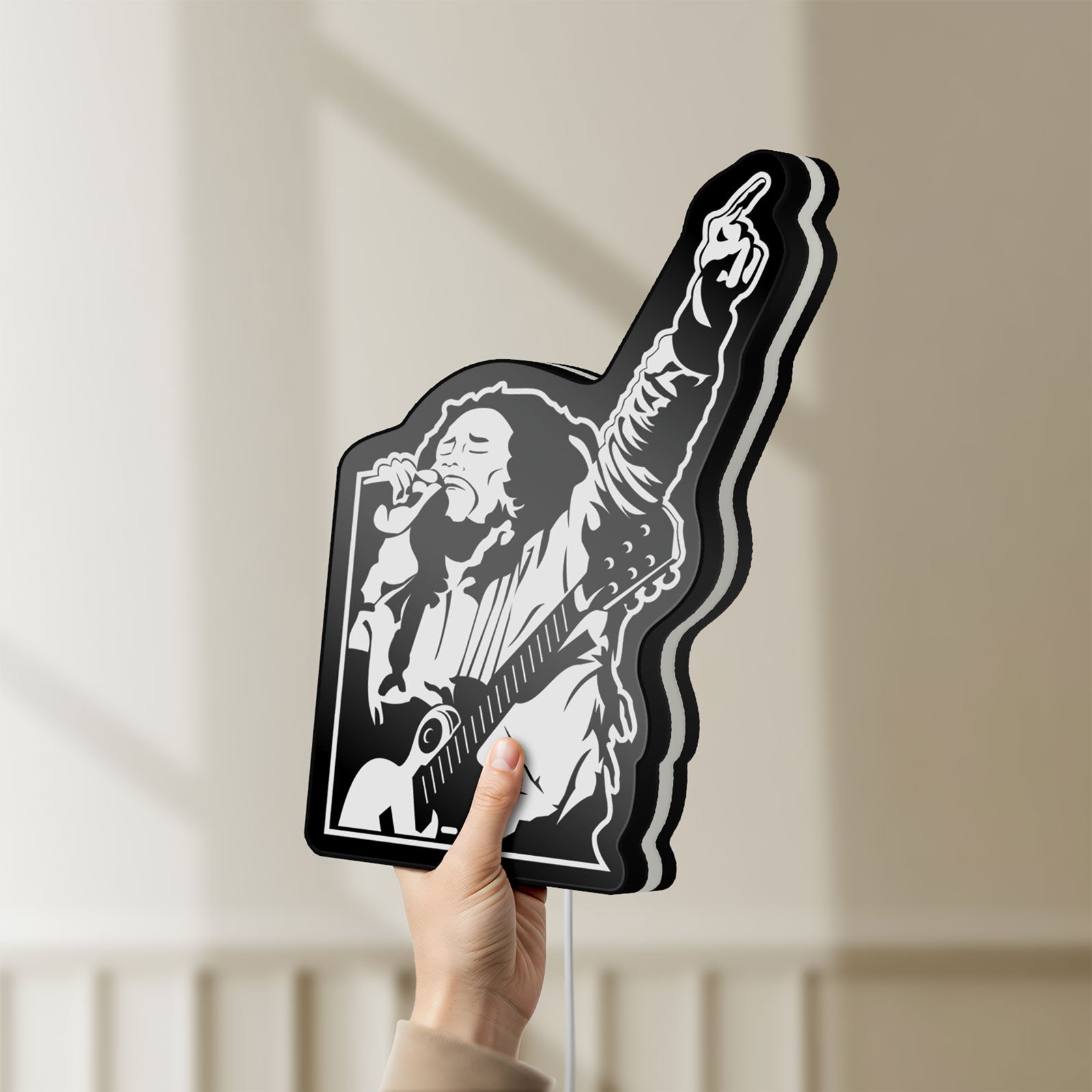 Unlit Bob Marley LED lightbox held by hand to show size and details