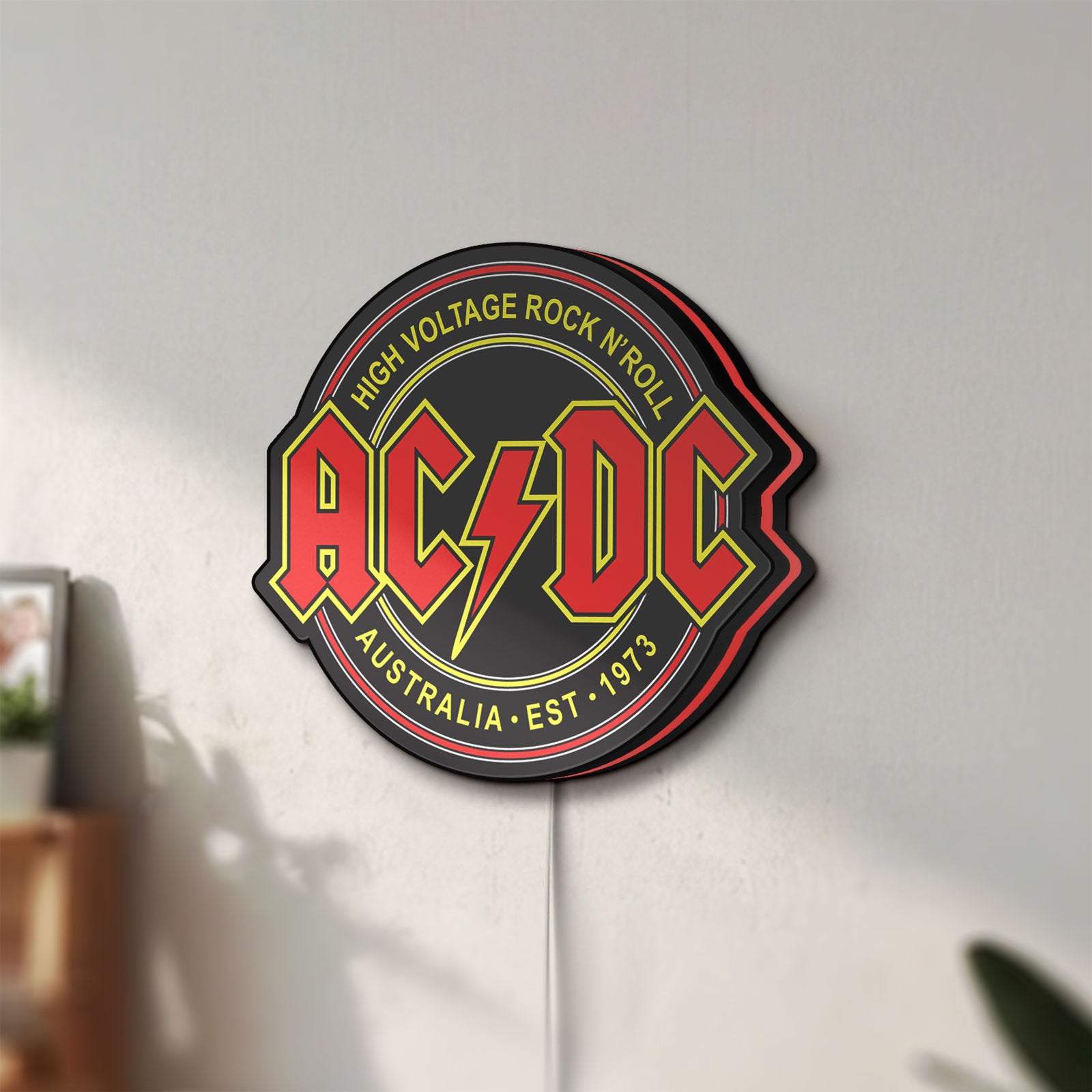 Unlit AC DC Rock N Roll LED lightbox mounted on a wall in daylight