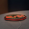 AC DC Rock N Roll LED lightbox lying flat on a desk with red glow