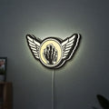 Kiss Army Fist LED lightbox hanging on a wall with white glow