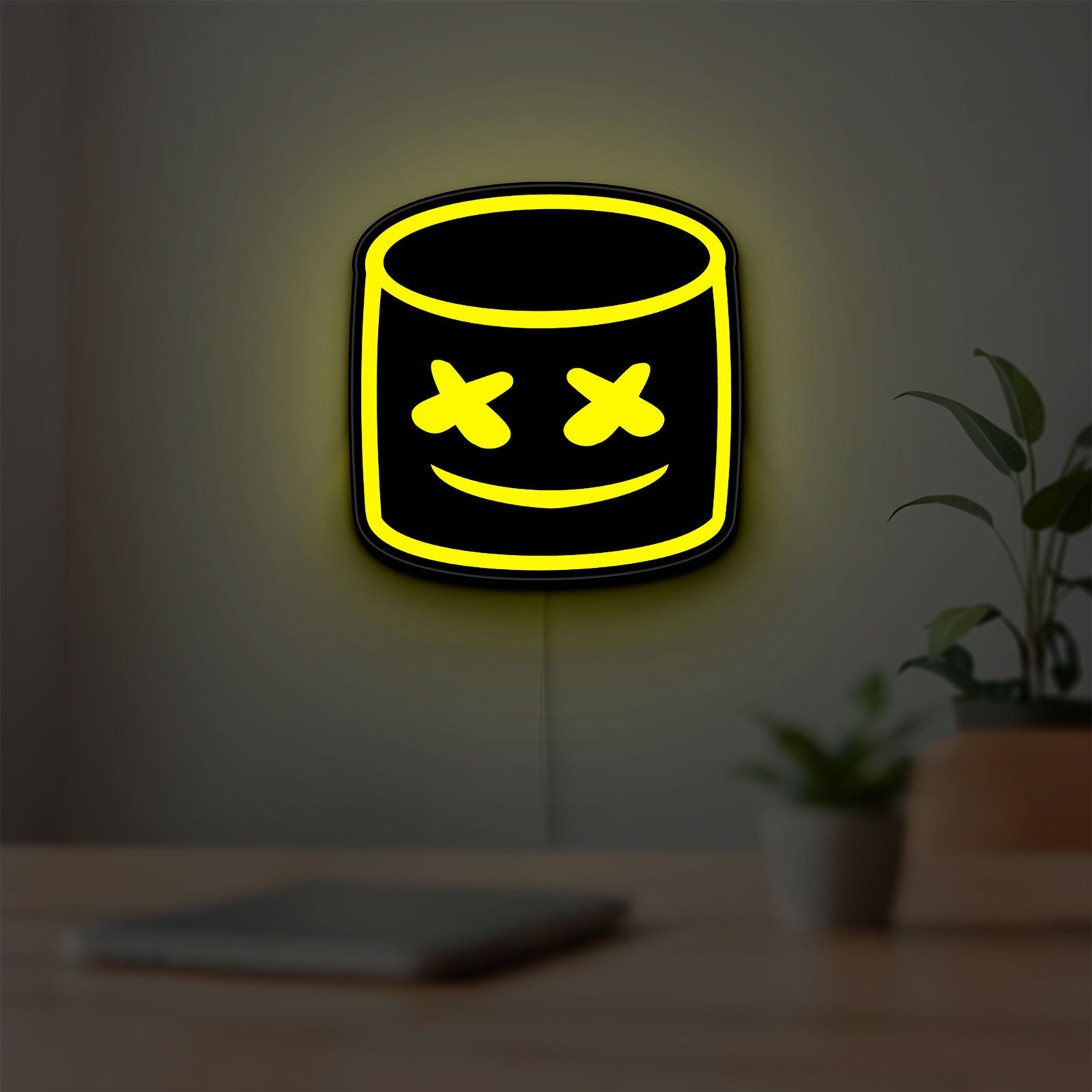 Marshmello LED lightbox hanging on a room wall with soft yellow light