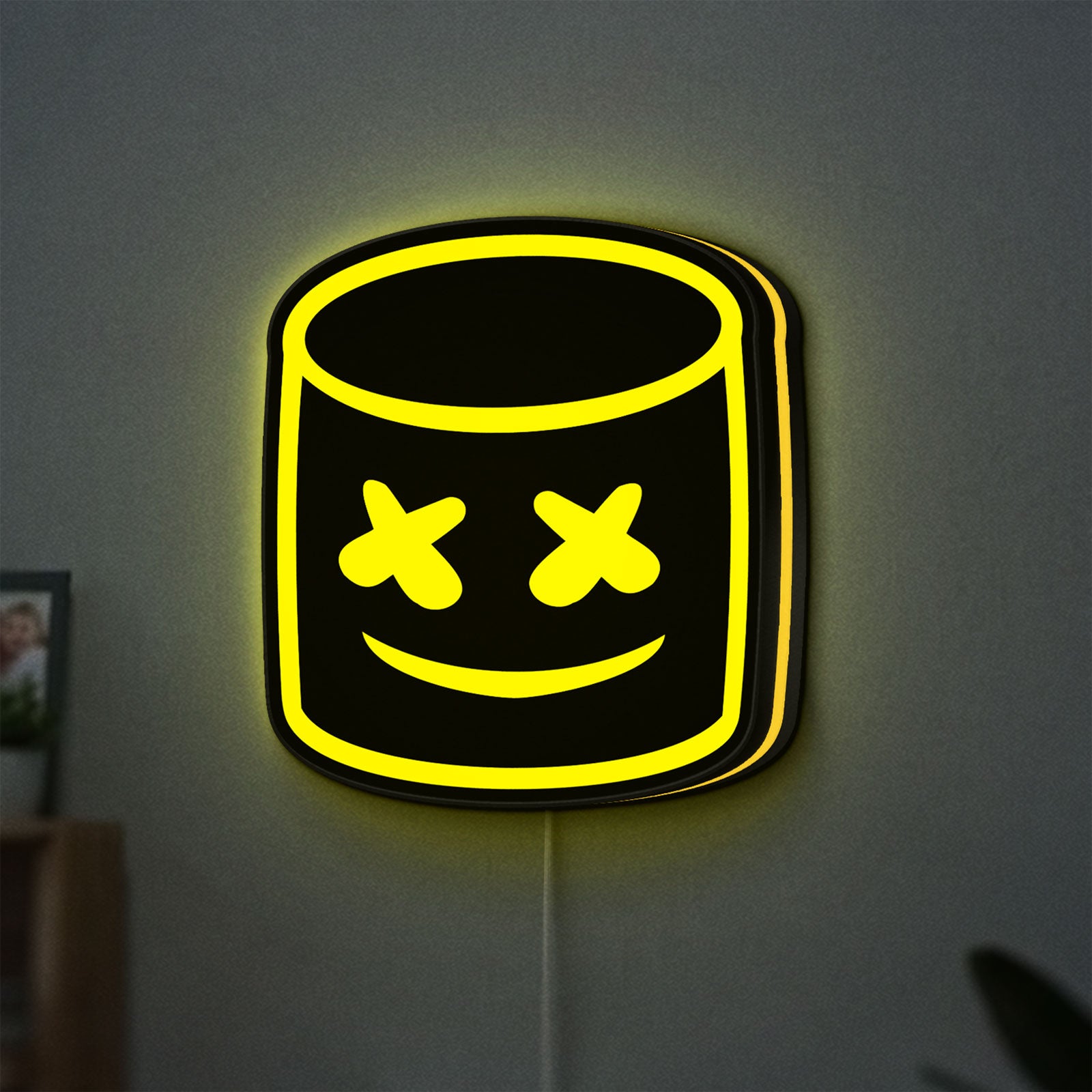 Marshmello LED lightbox hanging on a wall with yellow glow
