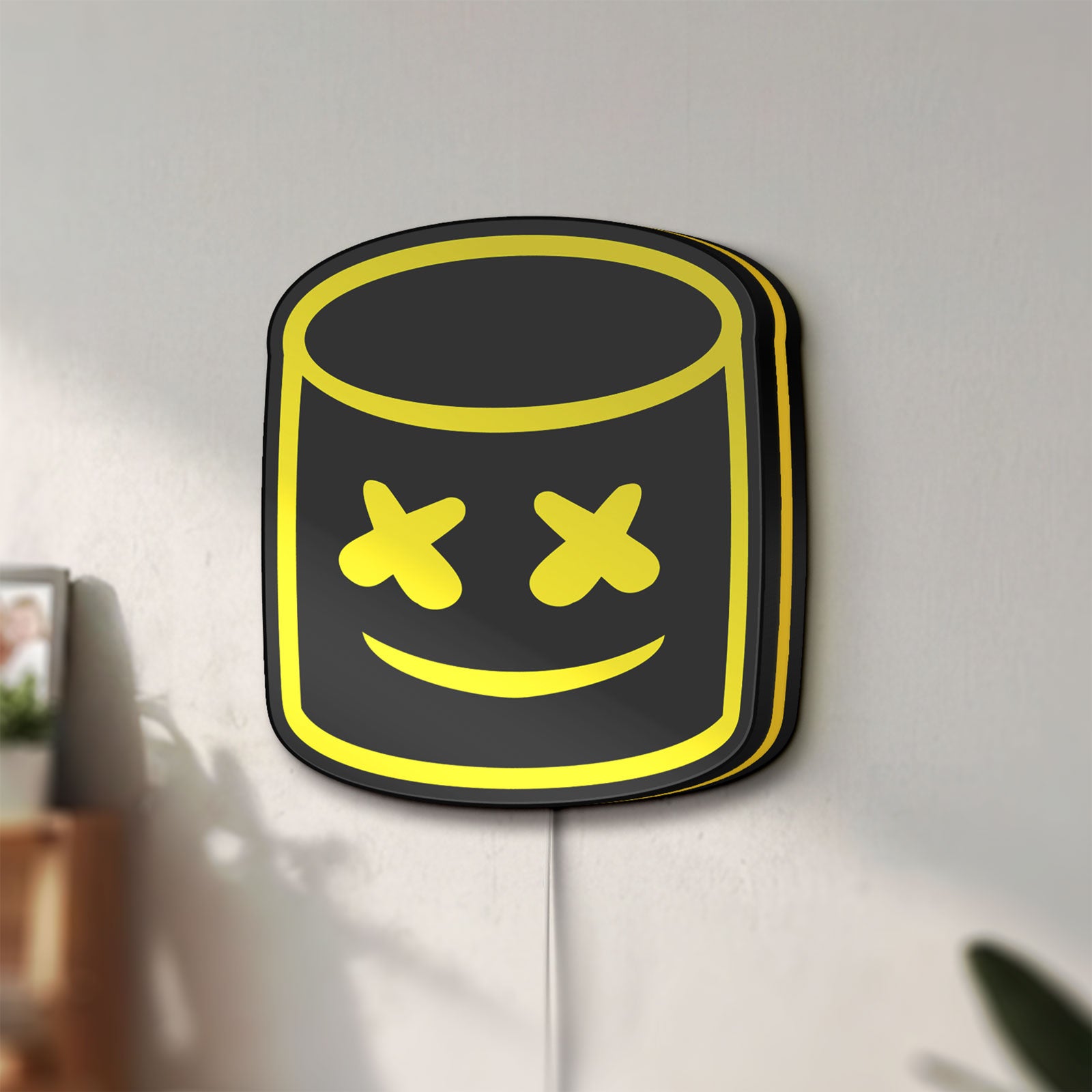 Unlit Marshmello LED lightbox mounted on a wall in daylight