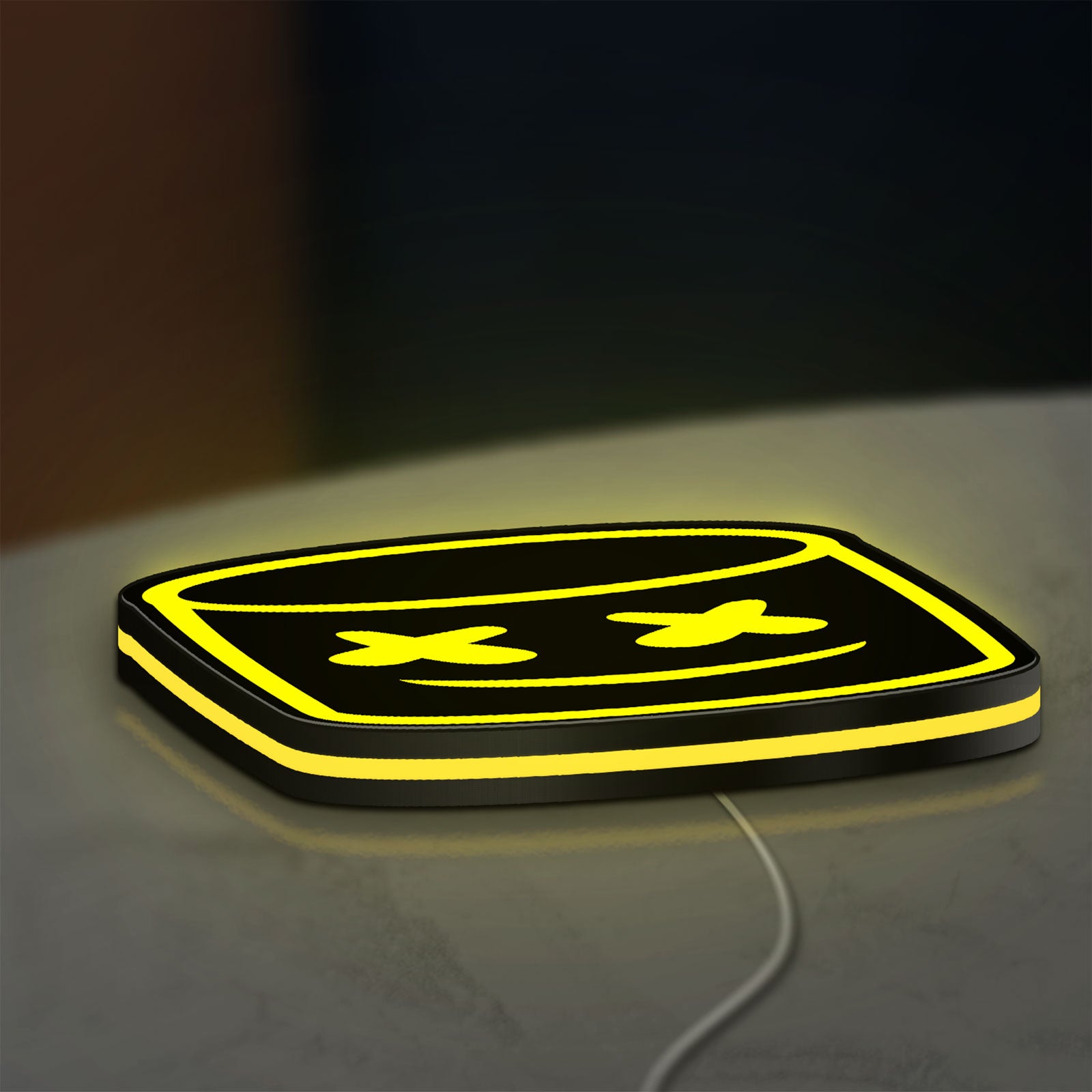 Marshmello LED lightbox lying flat on a desk with yellow glow