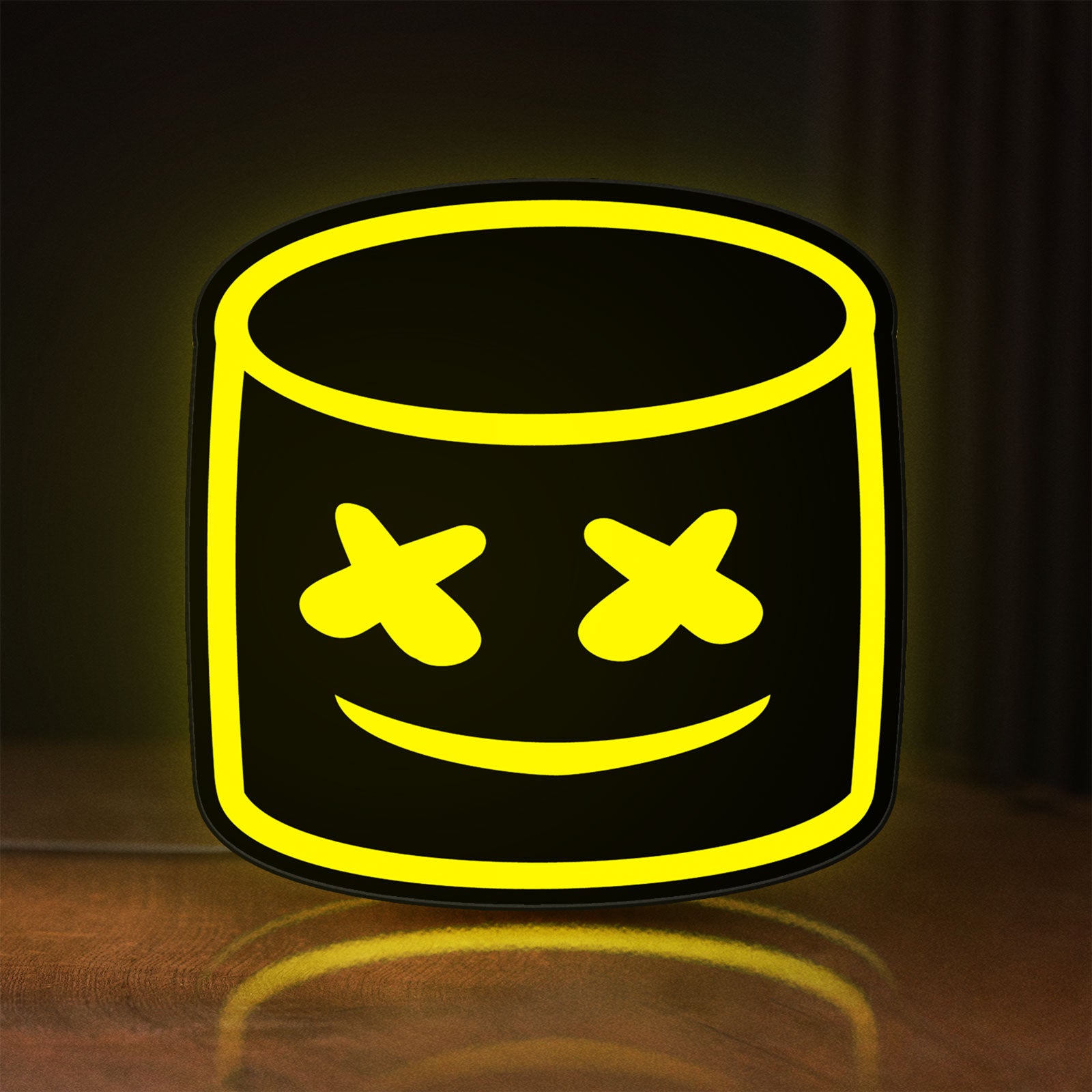 Front view of Marshmello LED lightbox sign glowing on a wooden desk