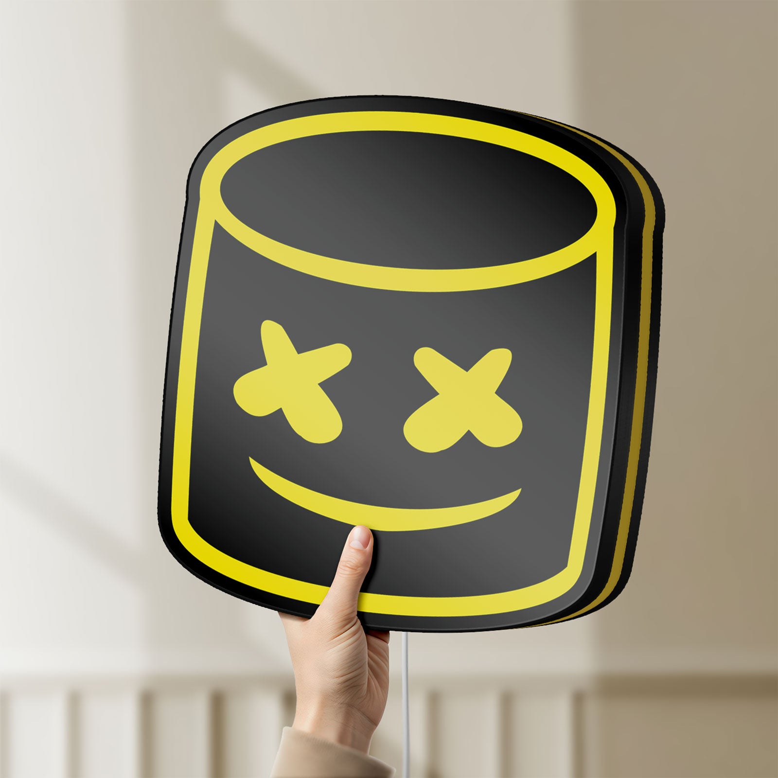 Unlit Marshmello LED lightbox held by hand to show size and details