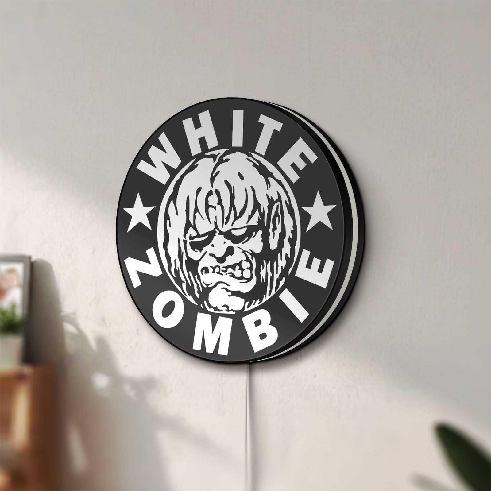 Unlit White Zombie Band LED lightbox mounted on a wall in daylight