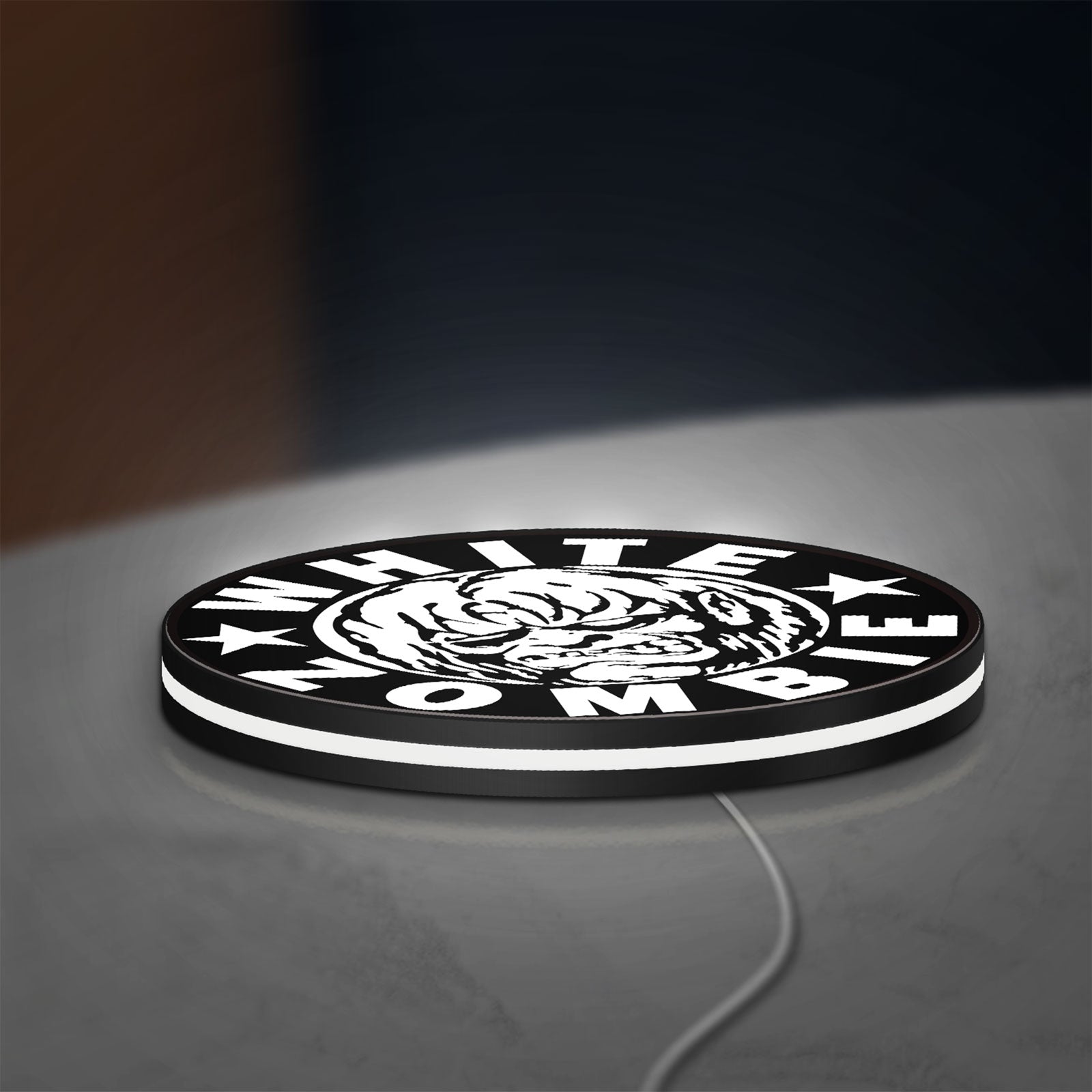 White Zombie Band LED lightbox lying flat on a desk with white glow