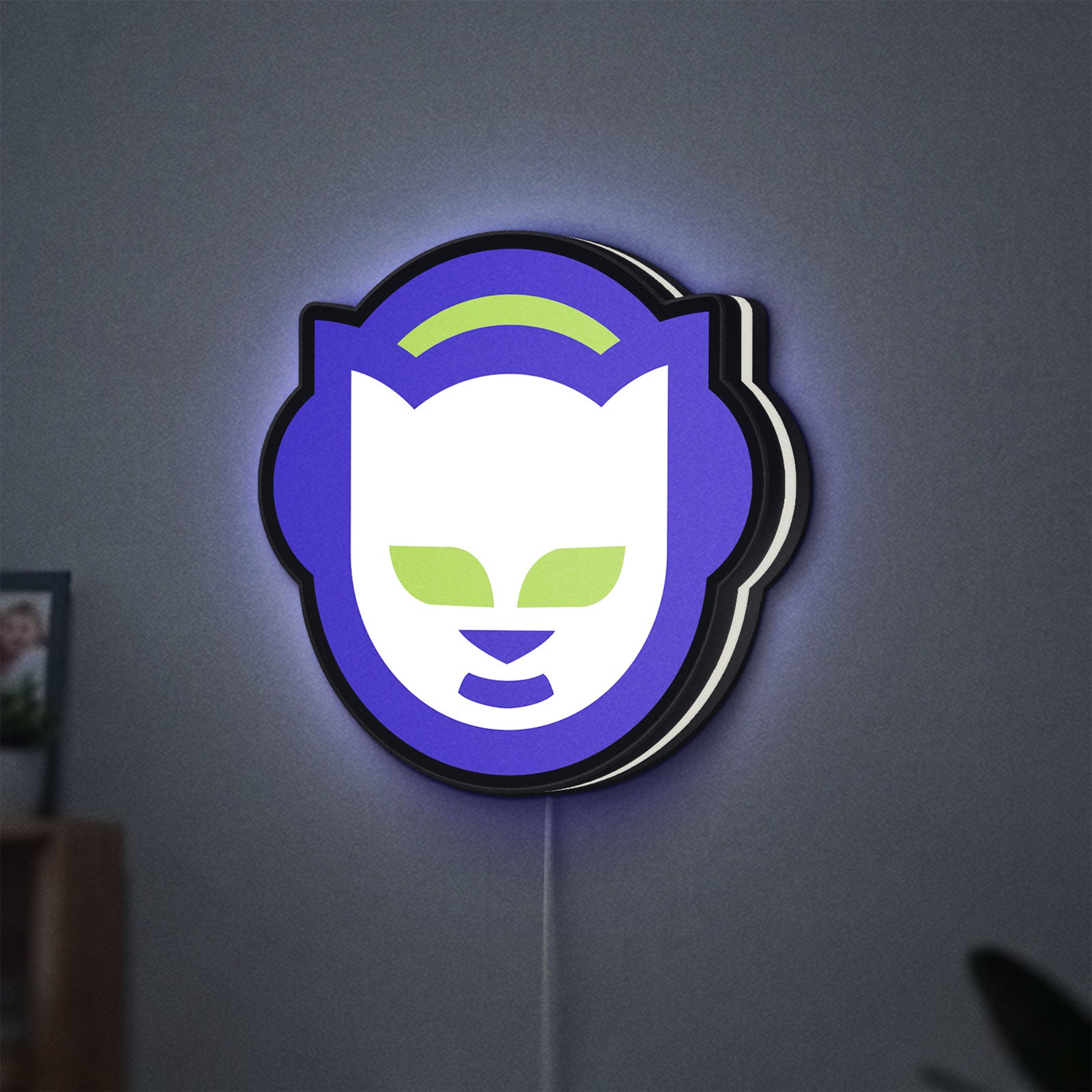 Napster LED lightbox hanging on a wall with white glow