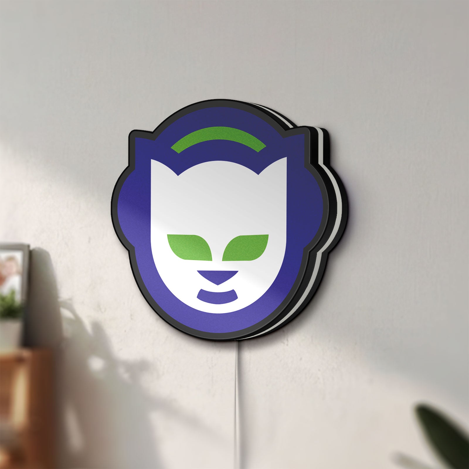 Unlit Napster LED lightbox mounted on a wall in daylight