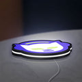 Napster LED lightbox lying flat on a desk with white glow
